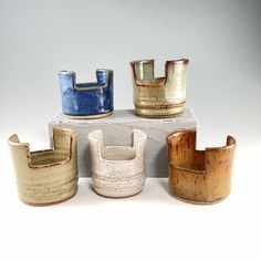 five different types of pottery sitting on top of each other