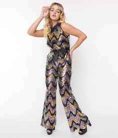 This groovy 1960's style jumpsuit from Smak Parlour is crafted in a knit blend and dazzles with multicolor sequins in a zig zag pattern. Outfitted with a black satin cowl neckline, back zipper and matching black satin self-tie sash to cinch your waist. 70s Disco Jumpsuit Outfit, Disco Clothes Women, 70 Disco Party Outfit, Fitted Sequin Disco Jumpsuits And Rompers, Soul Train Fashion, Authentic 70s Fashion, Disco Outfit Ideas, Flared Jumpsuit 70s, Disco Style Full-length Sequined Pants