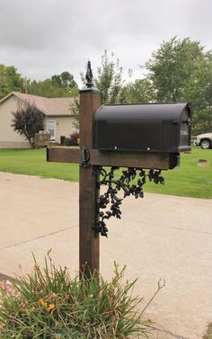 a mailbox is attached to a wooden post