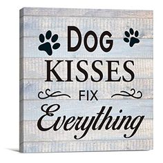 a wooden sign that says dog kisses fix everything with paw prints on the front and back