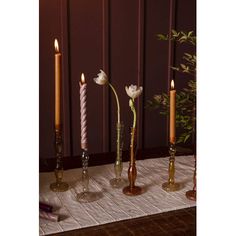 three tall candles are sitting on a table