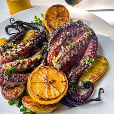 an octopus on a plate with oranges and other foods