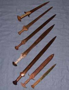 seven different types of knives on a blue cloth