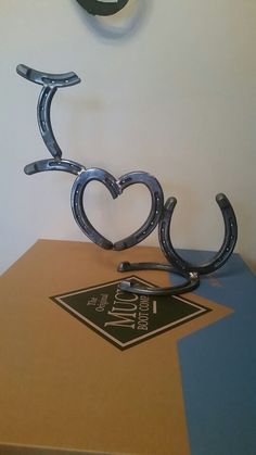 two horseshoes shaped like hearts sitting on top of a box