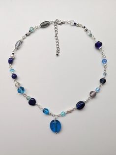 Embrace your adventurous spirit with our Boho Blue Heron Beaded Necklace. Handcrafted with care, this stunning piece combines the serene hues of blue and silver gemstones to evoke the tranquil beauty of a forest setting. Inspired by the majestic blue heron, symbolizing grace and freedom, this necklace features an earthy, woodland charm that's perfect for free spirits and nature lovers alike. Each bead is meticulously chosen and strung to create a harmonious blend of colors that reflect the calmi Blue Crystal Beaded Necklace, Cheap Blue Bohemian Long Necklace, Forest Setting, Boho Blue, Blue Heron, Blue Jewelry, Nature Lovers, Free Spirit, Chain Styles