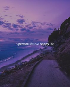 a path leading to the ocean with a purple sky and clouds above it that says, a private life is a happy life