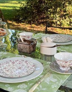 the table is set with dishes and cups