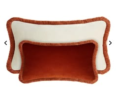 two brown and white pillows on top of each other