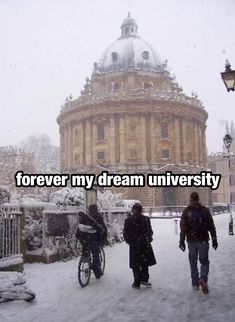 two people walking in the snow near a building with a quote on it that reads forever, my dream university