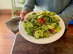 a white plate topped with lettuce and tomatoes