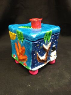 this is an image of a small toy box with decorations on the top and bottom