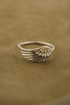 This ring has a sweet angel wing that fits horizontally on your finger. It is all sterling silver and very comfortable. Please let me know what size you need. I can make in a shiny polish also please see the 4th picture for this. The wing measures around 19 mm by 8 mm and the band is 16 gauge around 1.2 mm. Angel Wing Ring, Angel Ring, Put A Ring On It, Love Ring, An Angel, Little Miss, Cute Jewelry