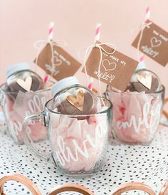 three mugs filled with candy sitting on top of a table