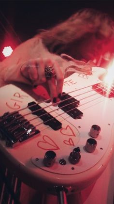 a person playing an electric guitar with numbers on it