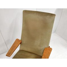 a brown chair with wooden arms and legs