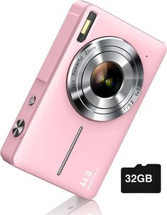 a pink digital camera sitting on top of a white surface