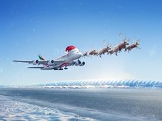 an airplane with santa claus's sleigh flying over the ocean