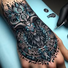 a person with a tattoo on their hand and an owl in the middle of it