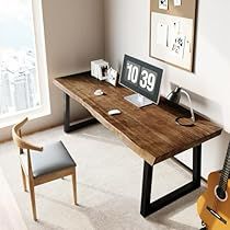 a desk with a guitar and clock on it next to a window in a room