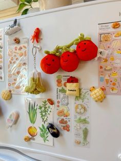 a refrigerator with magnets on the door and various items hanging from it