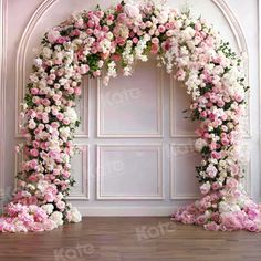 an arch covered in pink and white flowers