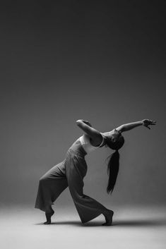 a woman is standing in the middle of a dance pose