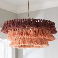 a chandelier hanging from a ceiling in a room with white walls and windows