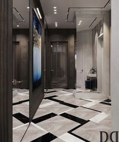 a hallway with black and white tile floors and mirrors on the wall, along with an art piece