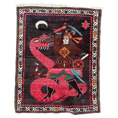 an old rug with a man riding a dragon on the back of it, and other items