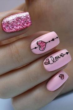 Cute pink valentines day nails with pink glittery heart shapes and word love on accent nail, and glitter pink accent nail... Mail Heart Design, Valentines Day Nails Ideas Short, Different Valentines Nails, Short Acrylic Valentines Day Nails, Valentine's Day Nail Designs Pink, Valentine’s Day Gel Nails, Valentine Gel Nails Ideas, Valentines Day Short Nails, Valentines Day Nails Glitter