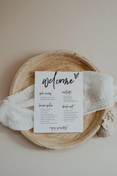 the welcome sign is placed on top of a woven basket with white yarn around it