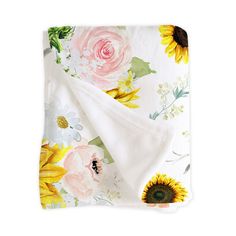 a blanket with sunflowers and flowers on it