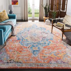 a living room filled with furniture and a colorful rug