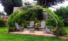 an outdoor area with lawn chairs and a pergolated structure in the middle of it