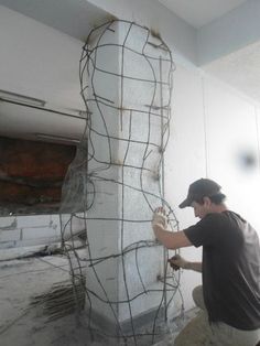 a man is working on a sculpture in the process of being painted and remodeled