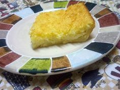 a piece of cake sitting on top of a white and multicolored ceramic plate