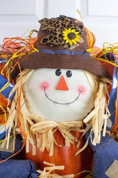 a close up of a pumpkin with a scarecrow on it