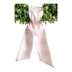 a pink and white checkered bow with green leaves