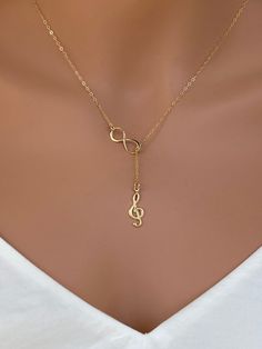 Sterling silver music charm necklace. Sterling Silver Treble Clef Music Charm. The perfect silver charm for music lovers and musicians. Sterling Silver Music Note Charm - Treble Clef 18x7mm This necklace is made of.... -18x7 S24k gold fill Music Note Charm - Treble Clef, -Gold plated on Sterling Silver infinity charm, -14k Gold Fill cable chain with spring clasp, -Come up with beautiful ribbon gift box and -One set of Care instruction package. MORE RELIGION NECKLACES https://www.etsy.com/shop/ra Music Jewelry Necklaces, Personalized Gold Music-themed Jewelry, Cheap Adjustable Music-themed Necklace, Music-themed Charm Jewelry As A Gift, Silver Music-themed Metal Necklace, Music-themed Charms Jewelry As Gift, Piano Teacher Gift, Music-themed Charms Jewelry For Gifts, Music-themed Jewelry Charms For Gifts