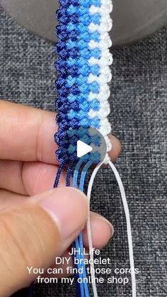 someone is stitching together some blue and white thread