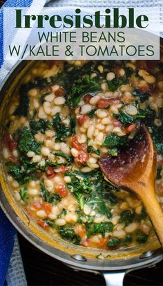 a pot filled with beans and spinach next to a wooden spoon