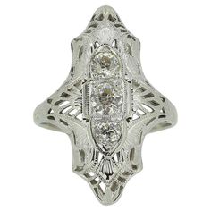 an antique style diamond ring with filigrees