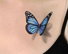 a blue butterfly on the back of a woman's chest