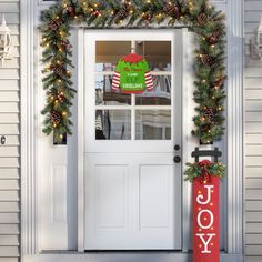 the front door is decorated for christmas with wreaths and lights