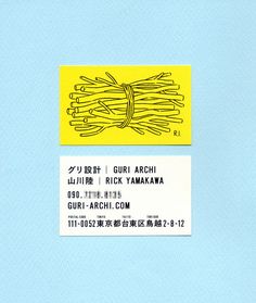 a yellow and white business card sitting on top of a blue surface with words written in chinese