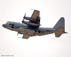 an airplane flying in the sky with another plane underneath it's landing gear on its wings