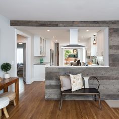 a living room and kitchen with wood flooring