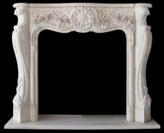 a white marble fireplace mantel with carvings on the top and sides, against a black background