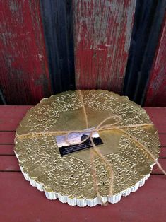 a cake with a tag tied to it sitting on a table