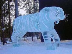 an ice sculpture of a tiger standing in the snow with trees in the back ground